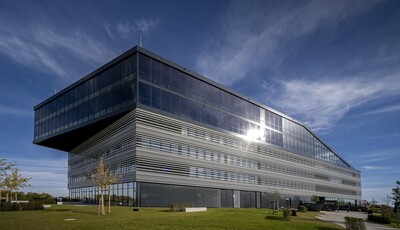 Exterior of custom shaped building with smart glass windows. 