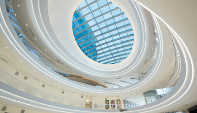 Interior of a multi-level building with smart glass windows as the ceiling.