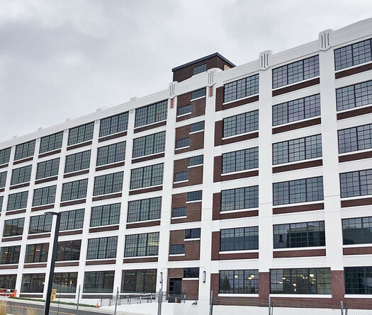 Exterior of industrial building with smart glass windows from left to right. 